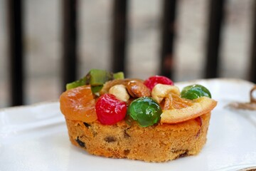Fruit rum cake on white on dish.