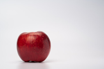 A syringe is injecting an apple, symbolic of vaccination and medical treatment