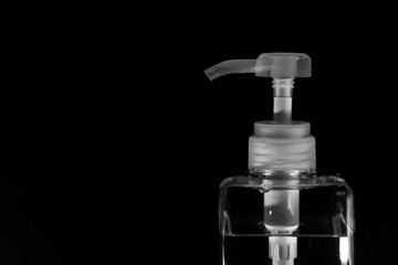 Fototapeta na wymiar Sanitizing bottle with black background