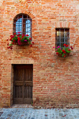 Potted plants grow in terracotta containers outside in the town of Certaldo, in the heart of Tuscany, Italy.