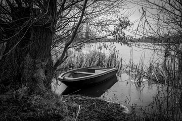  rowing boat is moored on the shore of a frozen lake