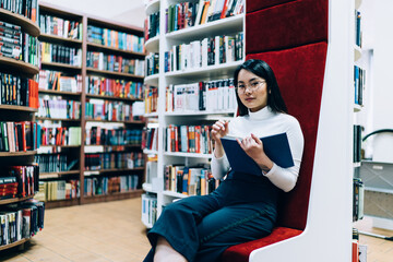 Asian female student sitting in library
