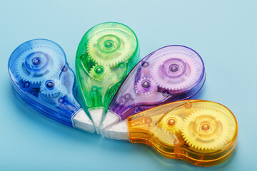Stationery correction tapes are Multicolored on a blue background.
