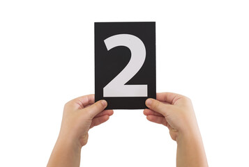 two hands are holding a black paper card with number 2 isolated on white background.