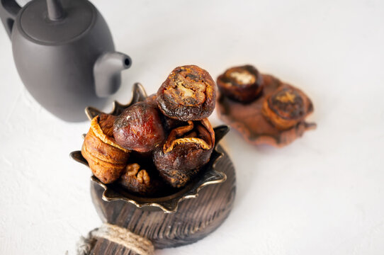Syrian sweets are served on the table. A mixture of Arabic sweets and dates of hastac. Dried fruit rolls stuffed with walnuts close-up. Selective focus. Small depth of field