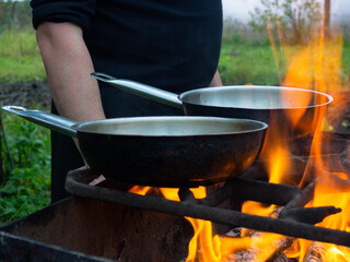 frying pan on a bright fire. cooking over a fire. burning bonfire