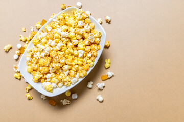 White, Caramel and Cheddar Popcorn in a White Bowl with Marshmallows and Gummy Bear candy