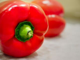 Selective focus of juicy red bell pepper on blurred background