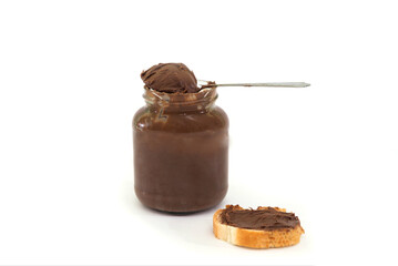 jar with delicious chocolate cream spread with a slice of baguette and a spoon isolated on white background.