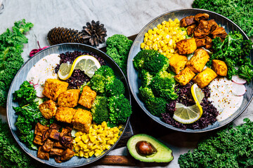 Green vegan breakfast meal in bowl with avocado, seeds and sprouts, top view. Clean eating, dieting, vegan food concept