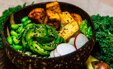Vegan food with grilled tofu and  buddha bowl top view.