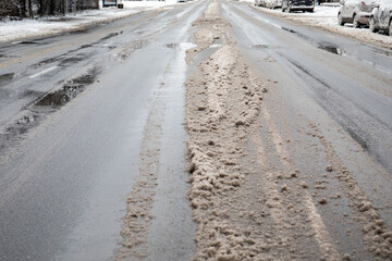 Naklejka premium Road clening from snow and salt sprinkle for faster melting
