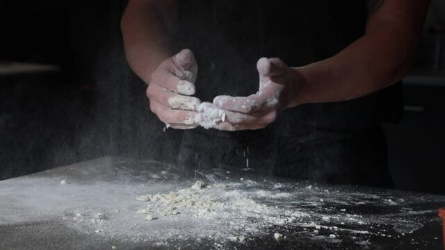 explosion of flour from the hands of a cook