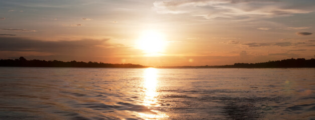 Sunset on the Amazon Amazon River, Amazon jungle, South America, clouds over the river, Peru, Ecuador