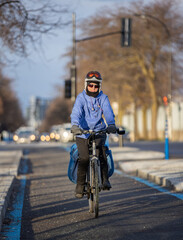 Fototapeta na wymiar Woman cycling in cold weather
