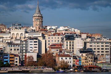 Fototapeta na wymiar Landscape view on the Istanbul embankment and Galata Tower under blue autumn sky