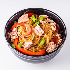 delicious glass noodles with tuna and vegetables on a white acrylic background