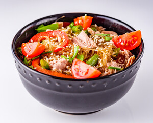delicious glass noodles with tuna and vegetables on a white acrylic background