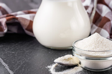 granulated milk powder on a dark stone background