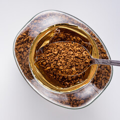 instant coffee granules on a white acrylic background