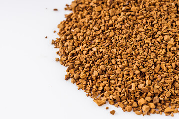 instant coffee granules on a white acrylic background