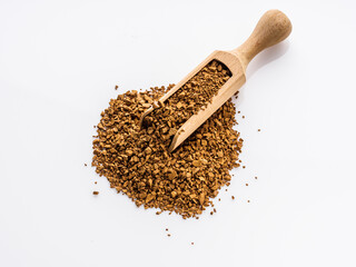 instant coffee granules on a white acrylic background