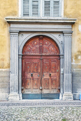 Italian retro wood style front door, element of the classic facade