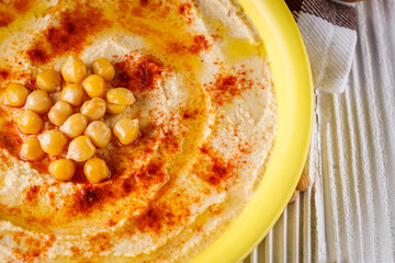 traditional turkish hummus on a white wooden rustic background