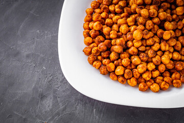 fried chickpeas on a dark stone background
