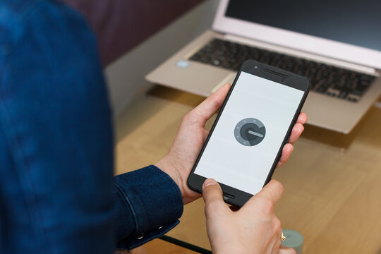 SAN FRANCISCO, US - 22 April 2019: Close up to female hands holding smartphone using Google Authenticator application, San Francisco, California, USA. An illustrative editorial image