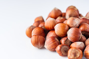 fresh natural hazelnuts on a white acrylic background