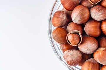 fresh natural hazelnuts on a white acrylic background