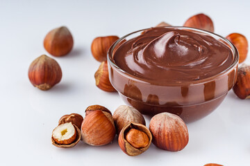 chocolate butter and hazelnuts on a white acrylic background