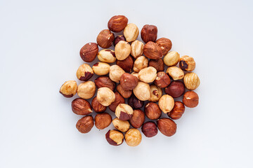 fresh natural hazelnuts on a white acrylic background