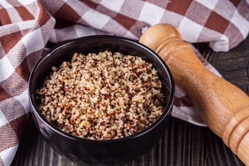 bowl of healthy quinoa on a dark wooden rustic background