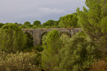 Fototapeta na wymiar Impressive 17th century built Aqueduct for transporting of water from Pegoes springs to Convent of Christ, Tomar, Portugal. Surrounded by lush green forests. Influenced- Roman and Muslim architecture.