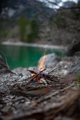 Safety precautions: Campfire near stone in a forest in order to avoid forest fire. Beautiful bonfire near the lake in the mountains