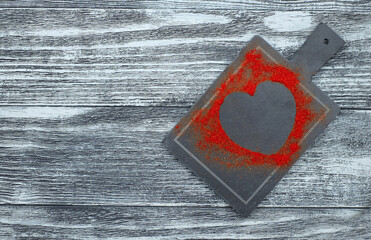 Red heart from paprika on the gray background, mock-up, with copy space