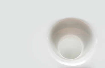 round hole in white plastic surface close up