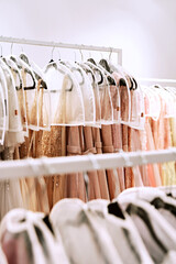 Various dresses in different colors on hangers in a rental service