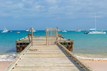 Obraz premium Old wooden pier and yachts, Punta Cana, Dominican Republic