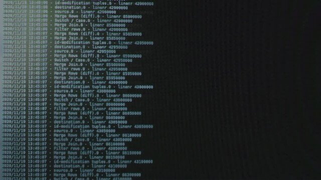 Blue computer software code moving on a black monitor. Computer hacking in process, dynamic text running and flowing on pc screen