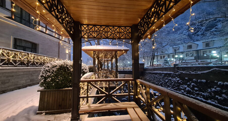 Obraz premium Crown Plaza Hotel Georgia, 2020.25.12. Borjomi, Borjomi River. New Year Holiday 2021. Gazebo with garland