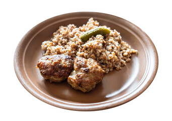 portion of fried Kotleta (breaded minced beef steaks) , side dish from boiled buckwheat porridge on brown plate cut out on white background