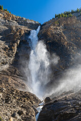 Takakkaw Falls Waterfall in a sunny summer day. 2nd tallest waterfall in Canada. Natural scenery landscape in Yoho National Park, Canadian Rockies, British Columbia.