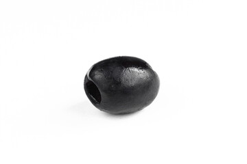 Single black olive isolated on white background. One dark fruit closeup