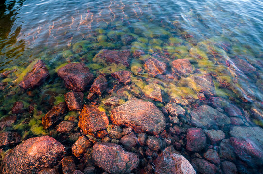 Coast of red granite boulders in the Aland Islands. Finland