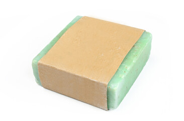 Green herbal soap isolated on white background. Homemade soap wrapped in blank paper