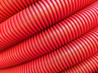 Red flexible corrugated pipe, used for protecting cables in electrical installation.