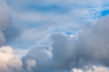 Beautiful cumulus clouds of different colors in the sky